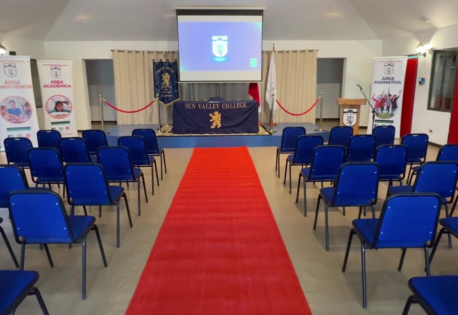 Salón de actos del colegio preparado para recibir a las familias postulantes